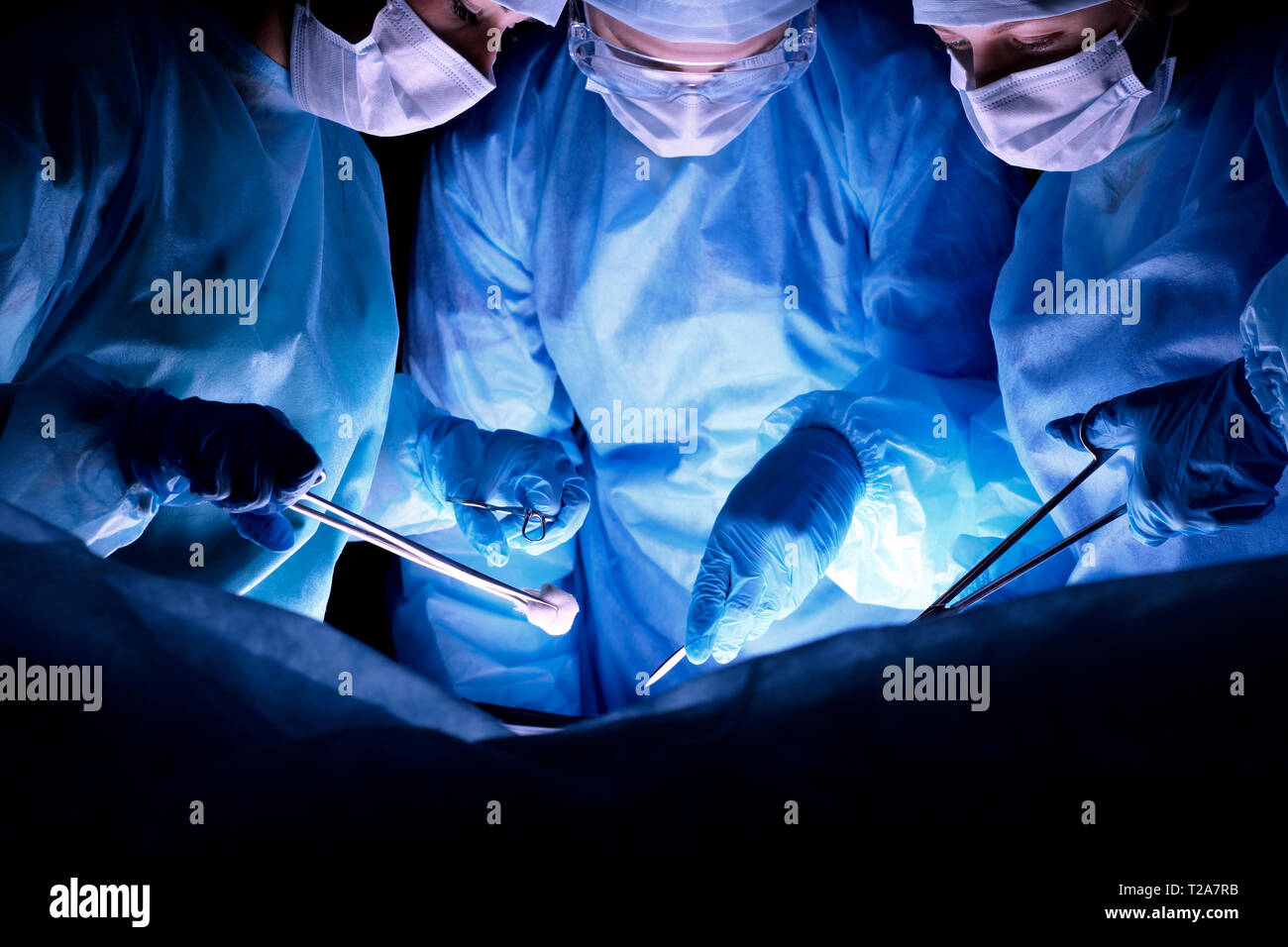 Group of surgeons in masks performing operation. Medicine, surgery and ...