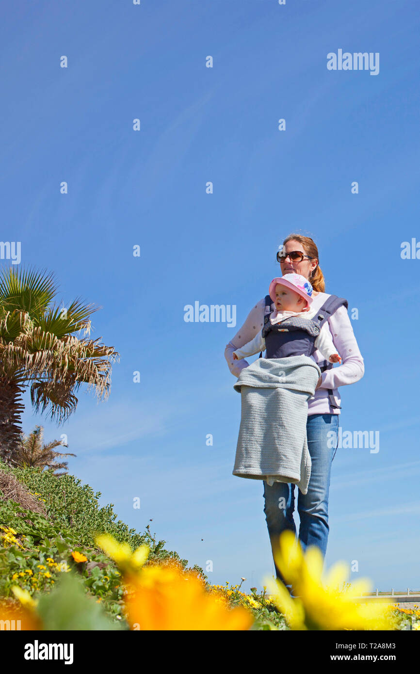 Mom and baby in a baby harness Stock Photo