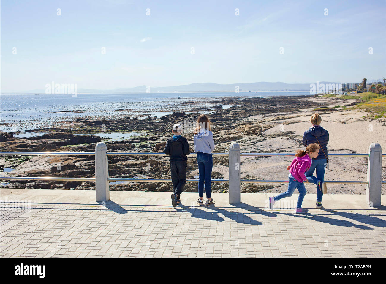 A mother and her three kids at the Sea Point Promenade Stock Photo