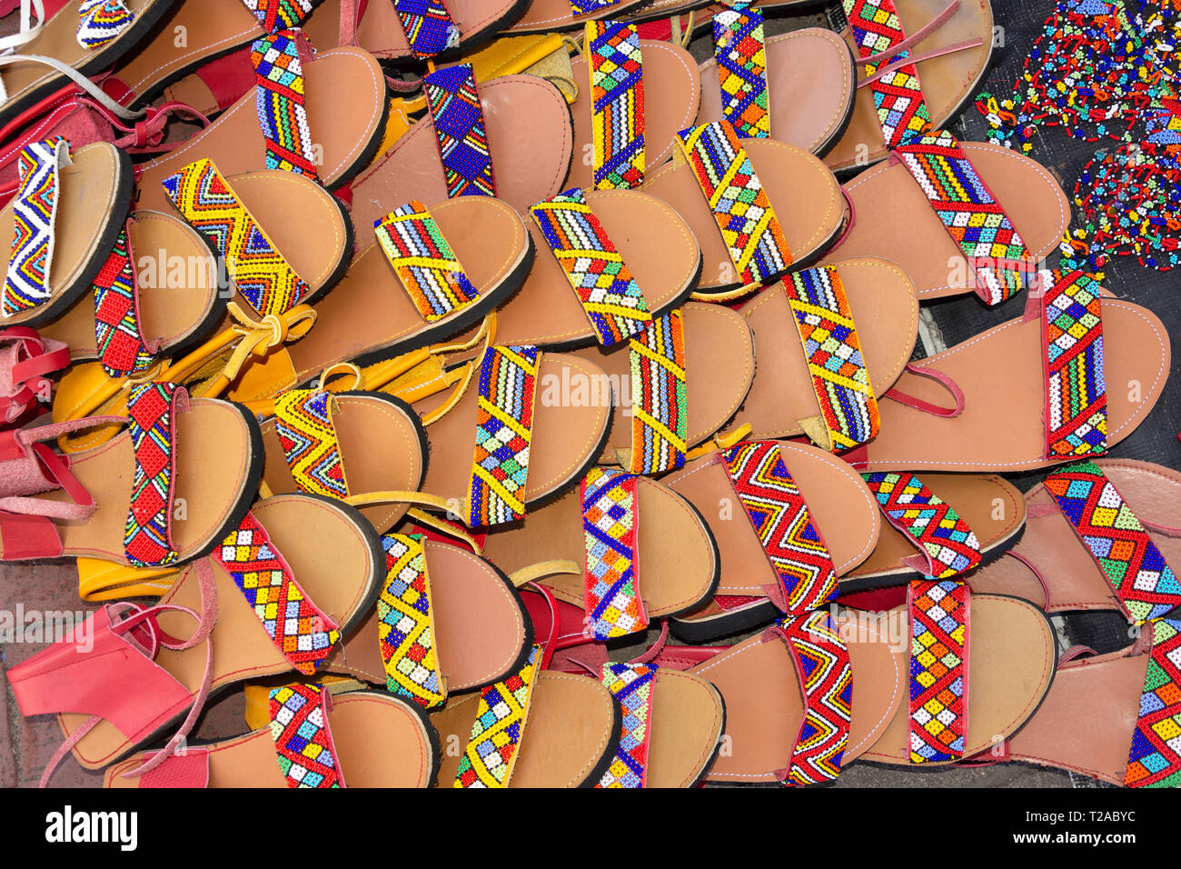 Colourful Zulu beaded sandals in souvenir stall, Snell Parade, Durban, KwaZulu-Natal, South Africa Stock Photo