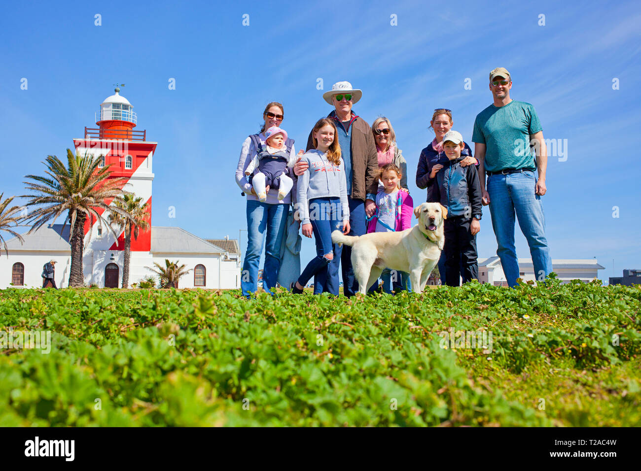 A family and their dog by the lighthouse on the promenade, Sea Point, Cape Town. Stock Photo