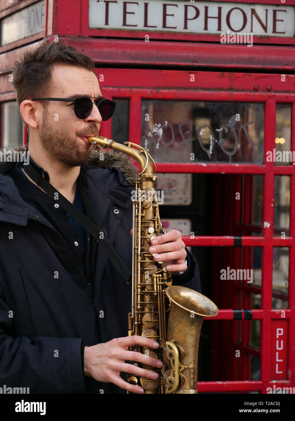 Street entertainment by a musician saxophone player near Piccadilly