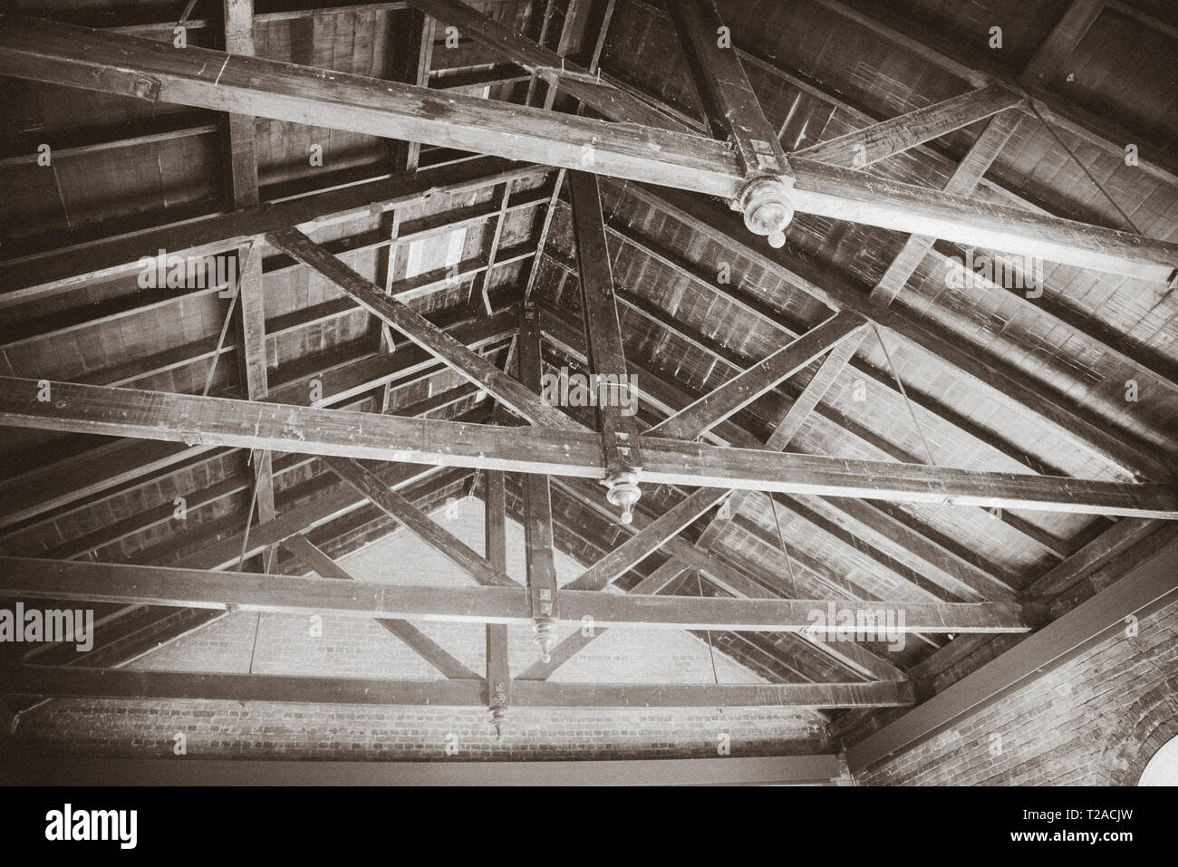 Underside of wooden roof showing support beams, black and white. Stock Photo