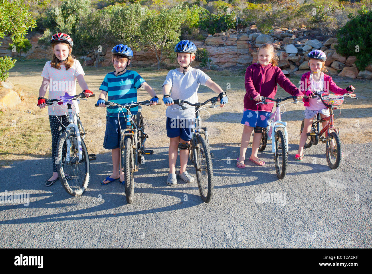 Five young kids on bicycles at Infanta. Stock Photo