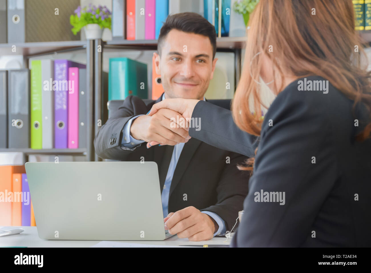 Negotiating business, businesswomen with businessman Handshaking happy with success of work , enjoying with workmate, Handshake connection Deal Concep Stock Photo