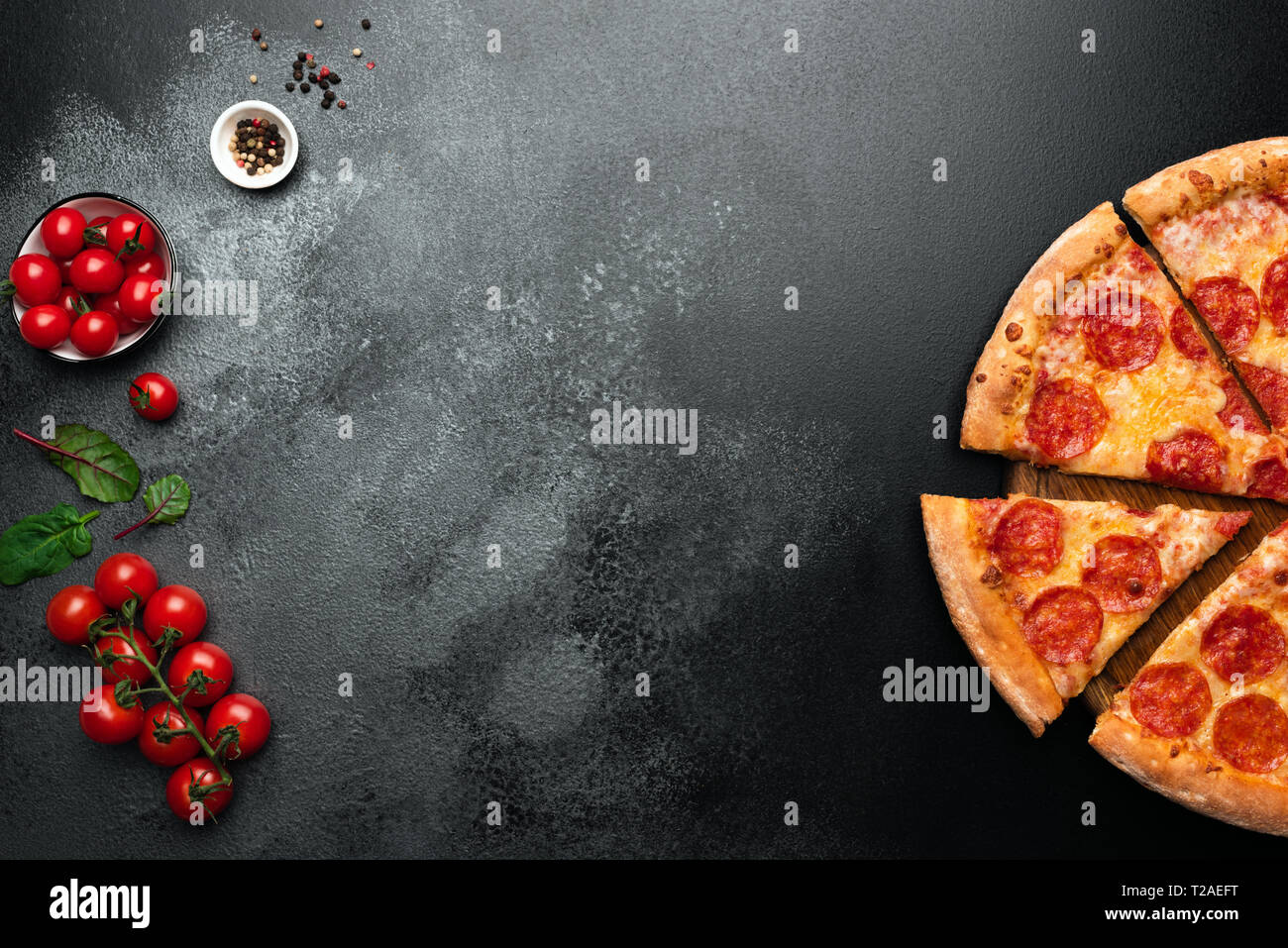 Pepperoni pizza on black slate background with copy space for text. Top view Stock Photo