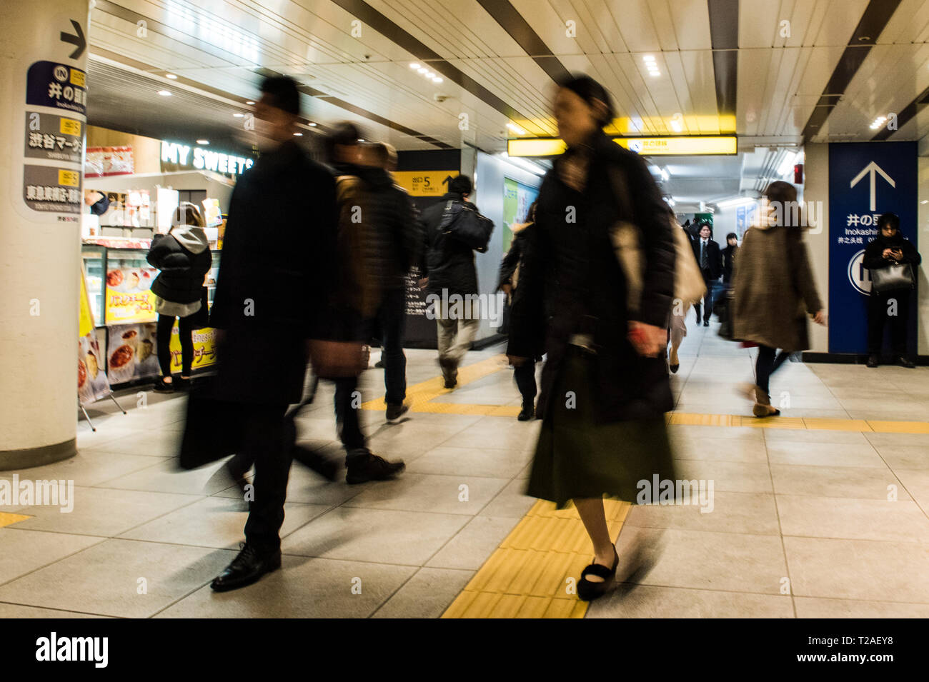 Commuters walking through station on Tokyo Underground, blurred motion, Tokyo, Japan Stock Photo