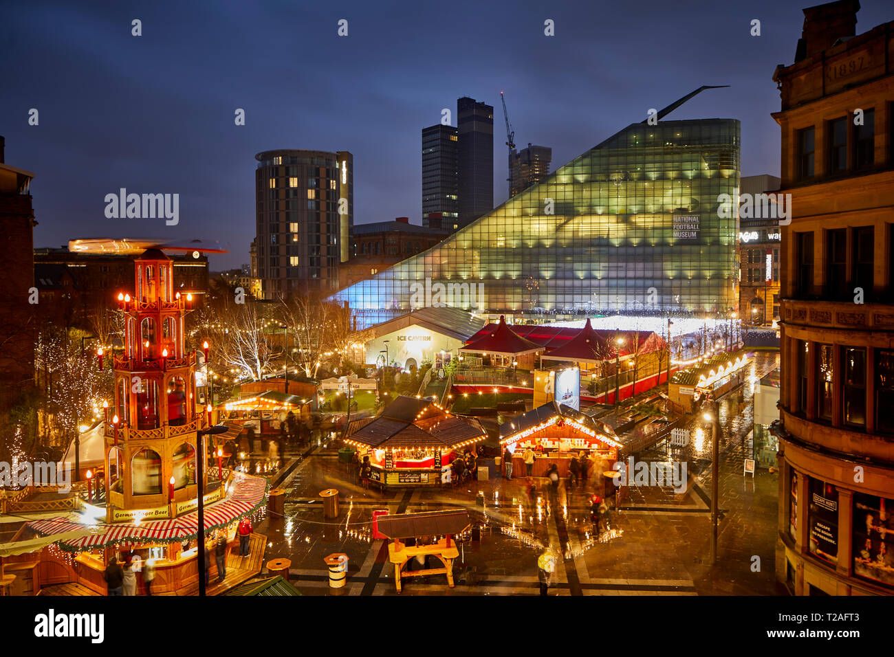 Early evening night at Manchester city centre European German Christmas Markets 2018 Ice Village in Cathedral Gardens - German Erzgebirge Pyramid Stock Photo