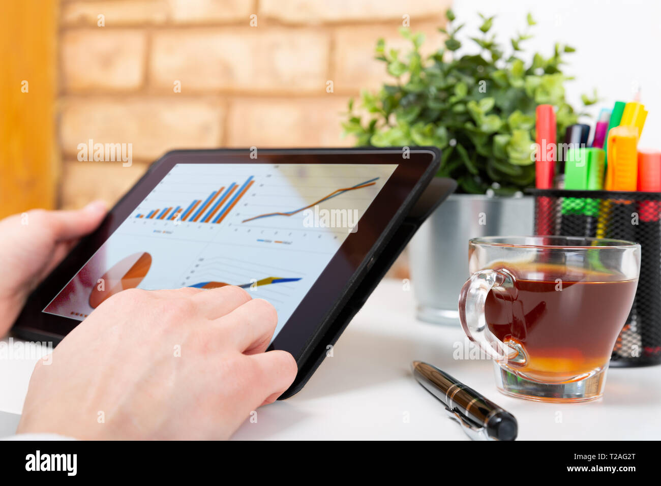 Data analysis concept shown on a tablet held by a woman Stock Photo