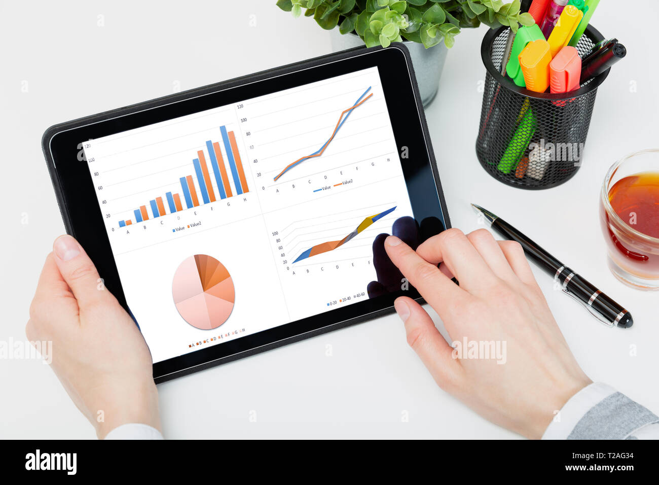 Data analysis concept shown on a tablet held by a woman Stock Photo
