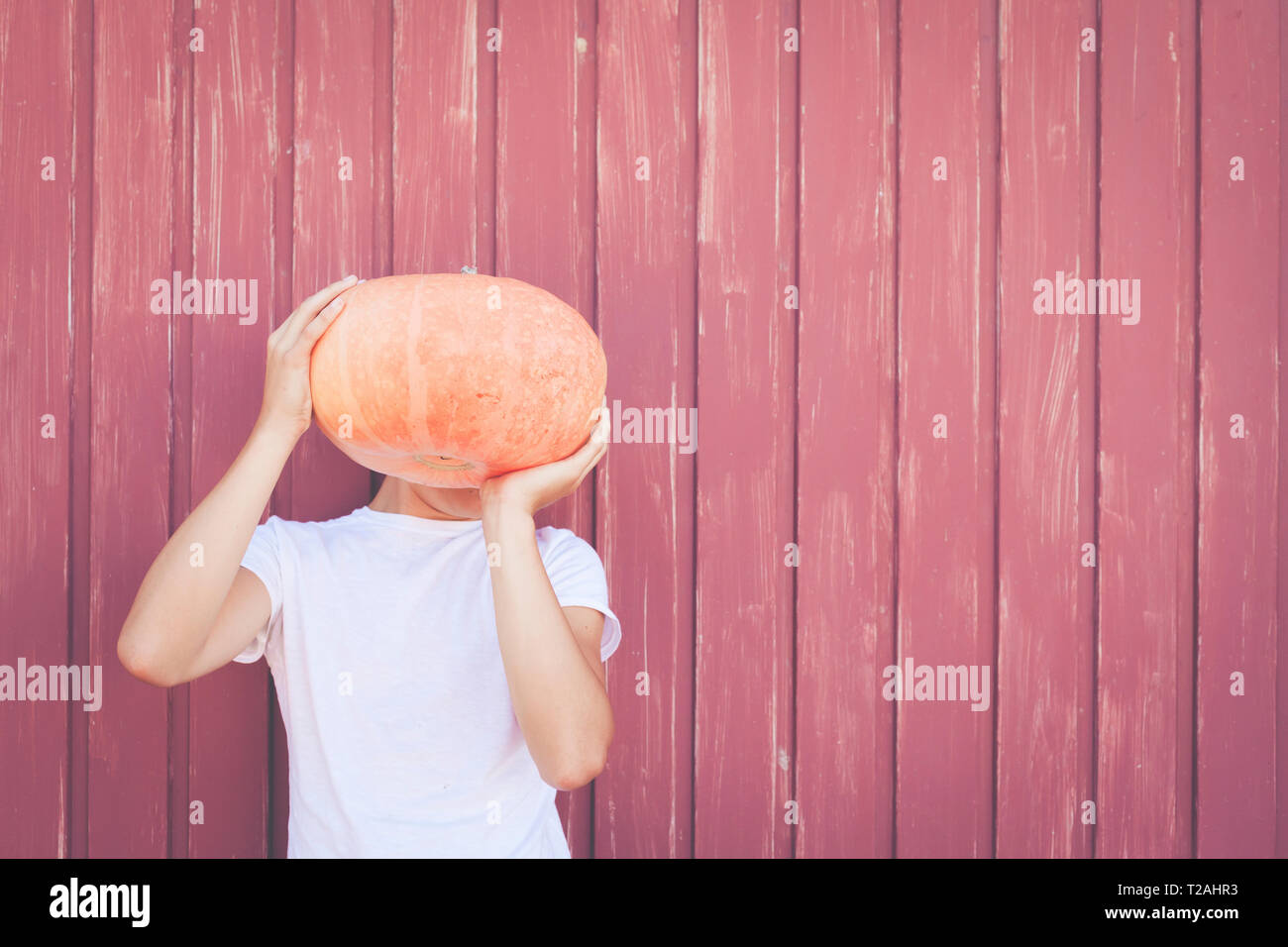Young man holding pumpkin over his face Stock Photo - Alamy