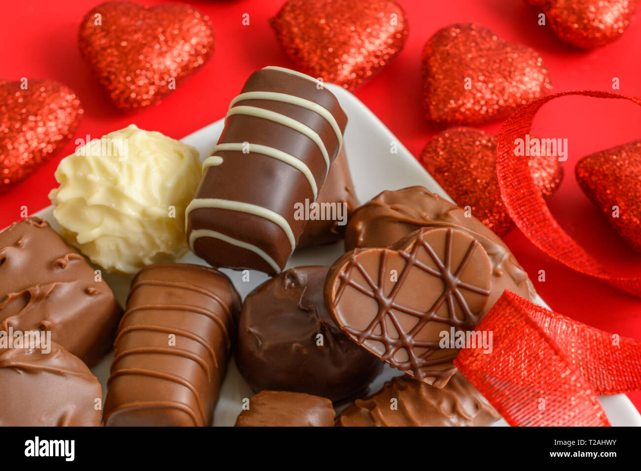 Assorted chocolates with red hearts Stock Photo