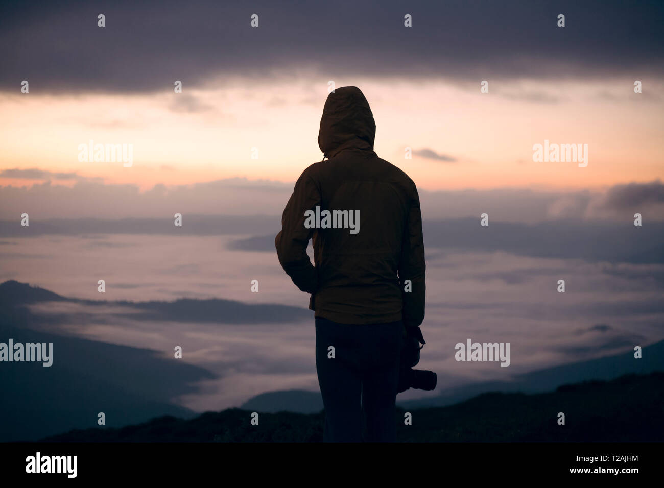 Silhouette of young man with camera at sunset in the Carpathian ...