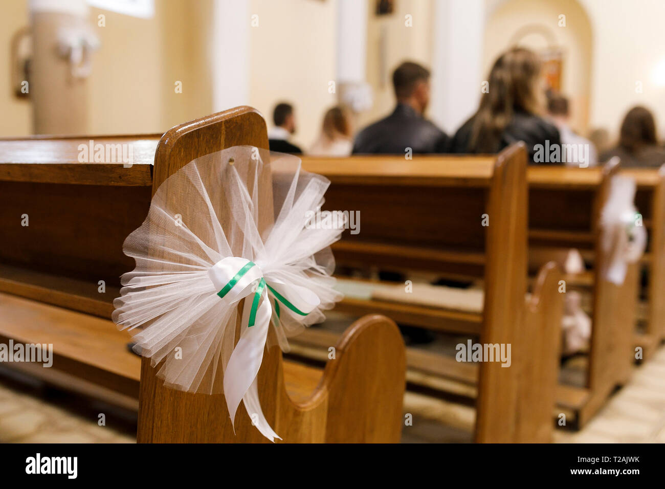 Tulle wedding decoration on pew Stock Photo