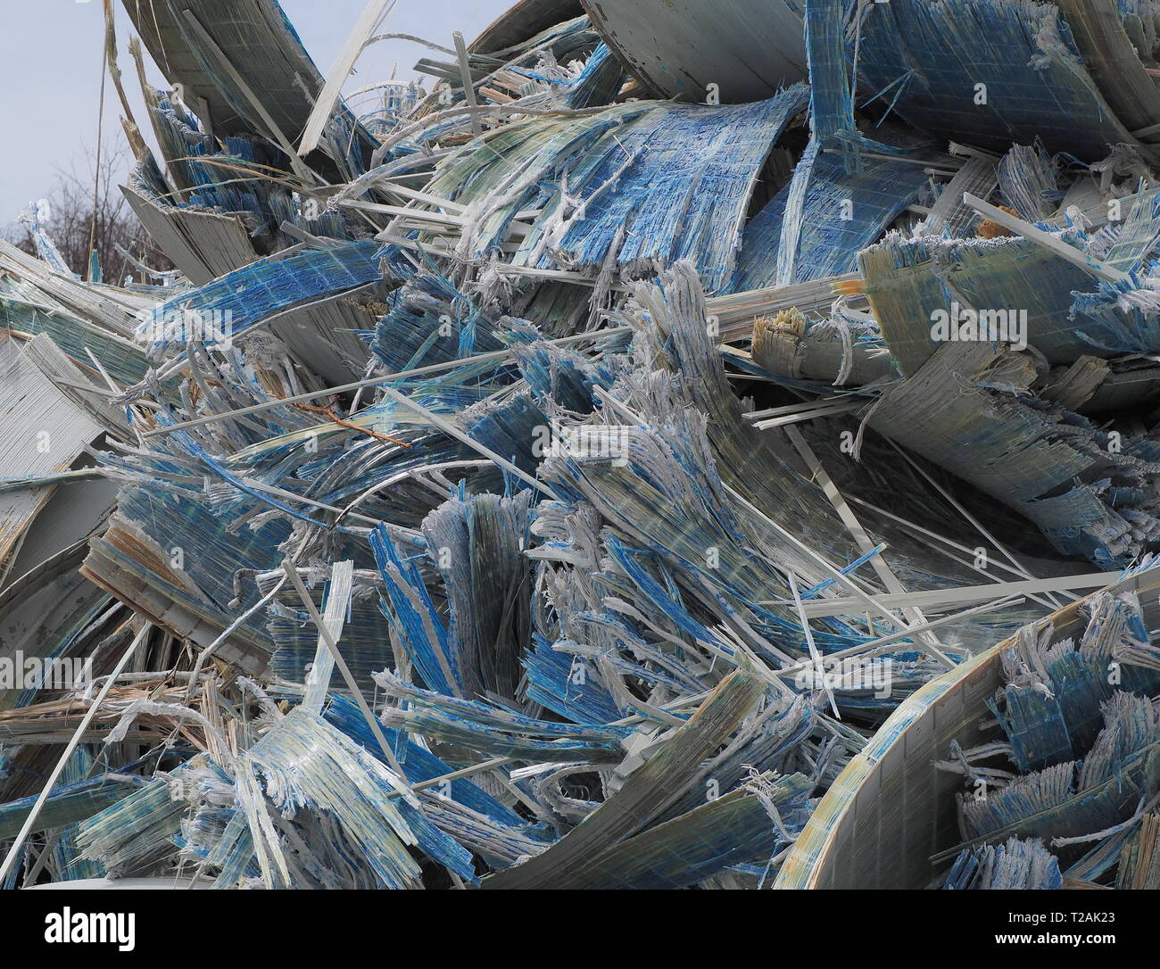 Pile of recyclable fiberglass scrap cut up by a excavator with a metal shear Stock Photo