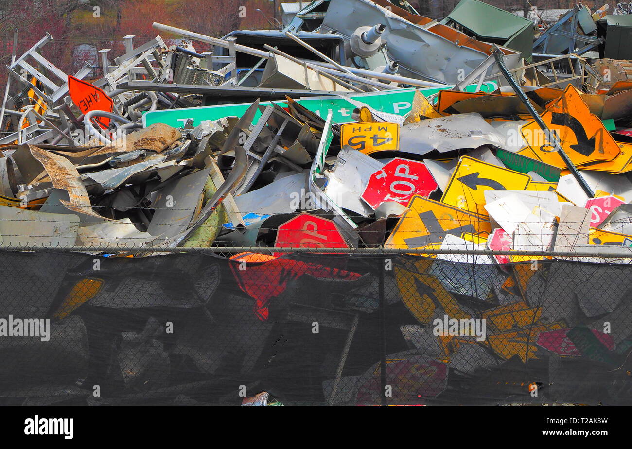 Abandoned road signs in a scrap yard, modern recycling Stock Photo