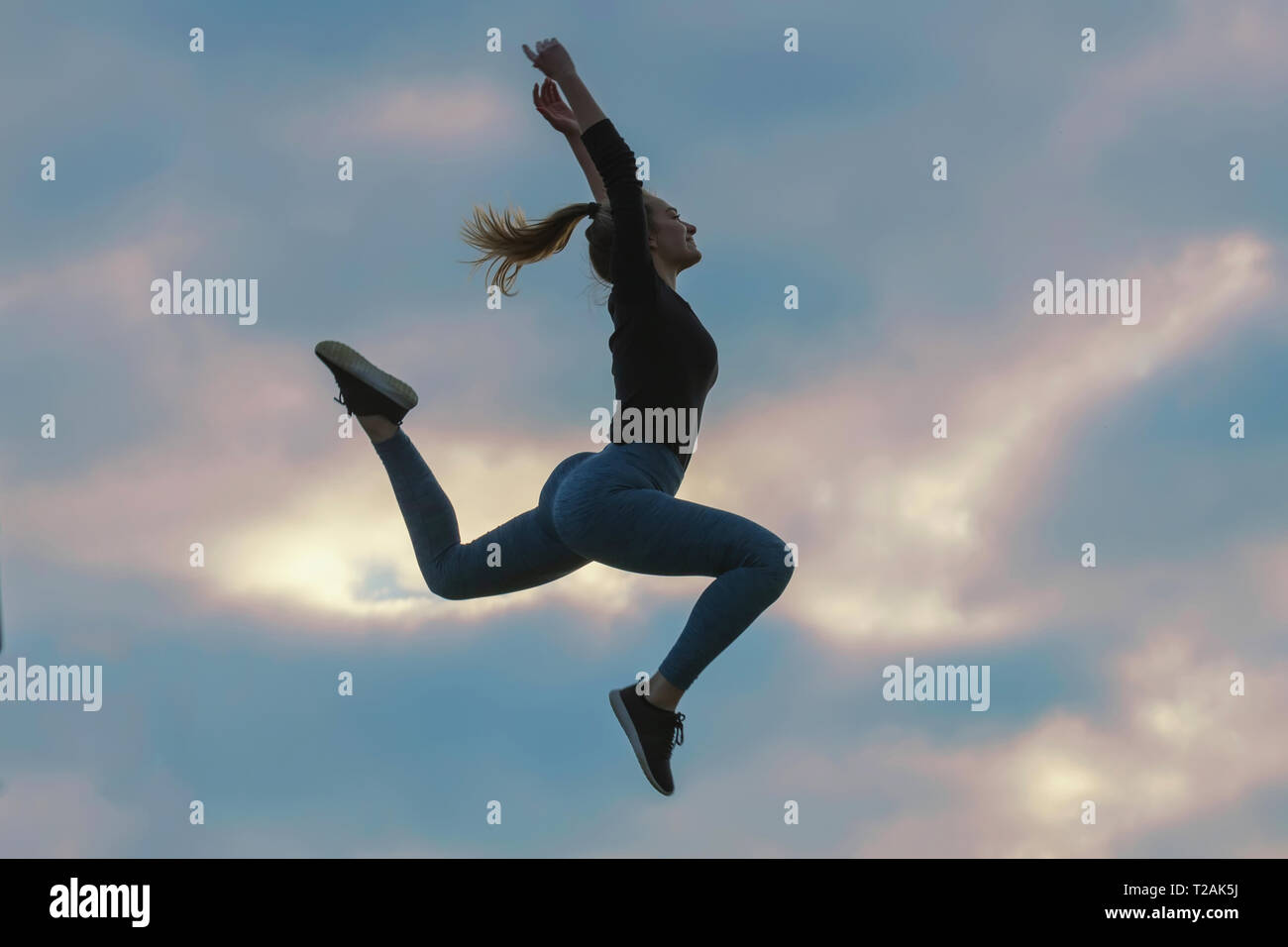 Cheerful Positive Girl Jumping in the Air Outdoor Morning Clouds ...