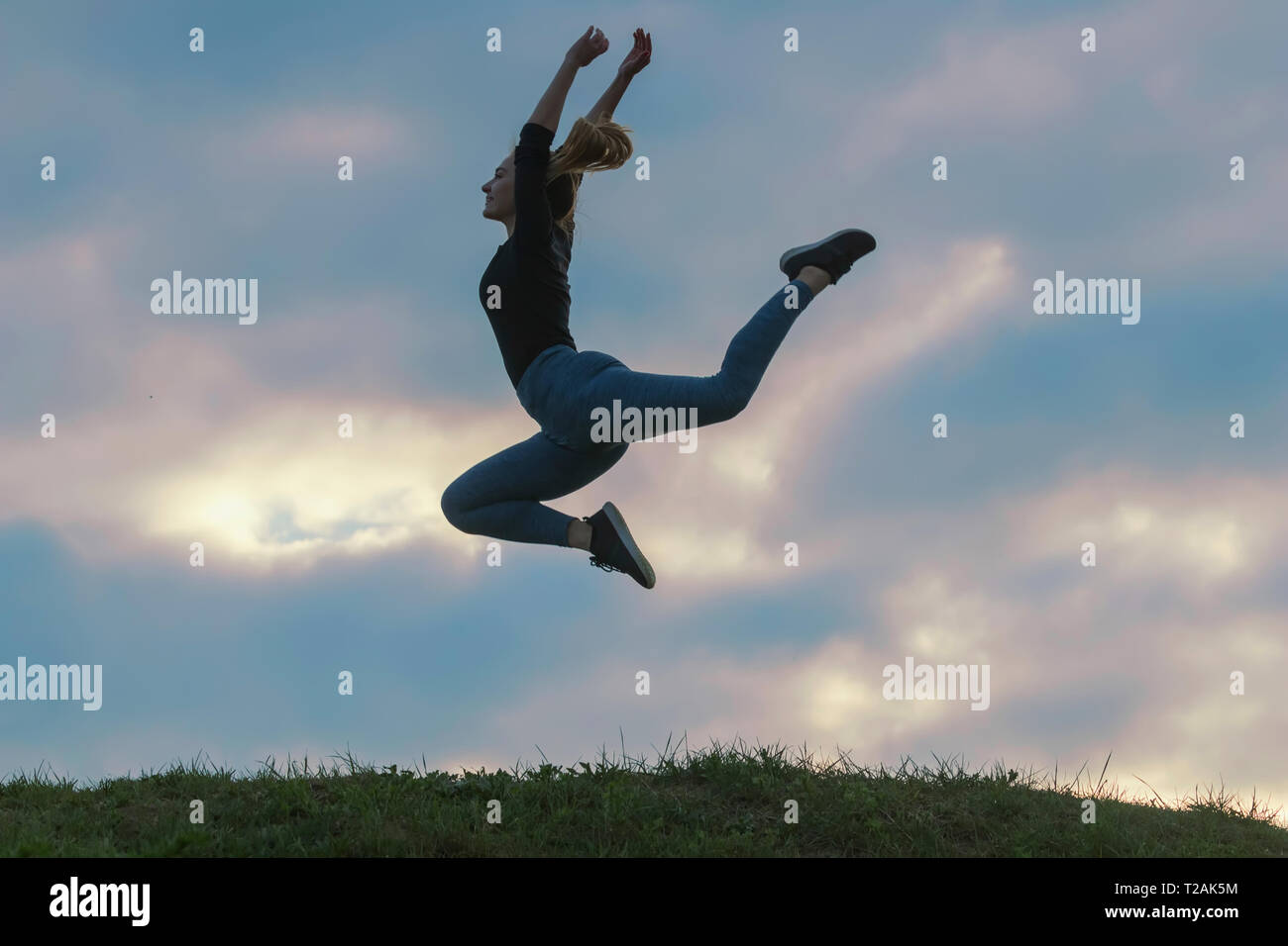 Cheerful Positive Girl Jumping in the Air Outdoor Morning Clouds ...