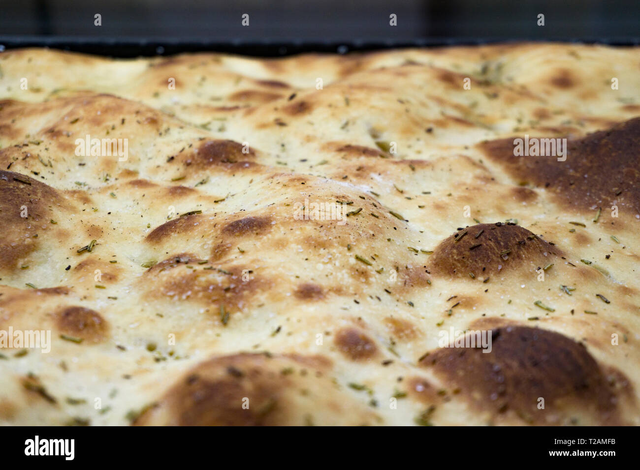 Typical Italian bread starter called Focaccia con rosmarion Stock Photo