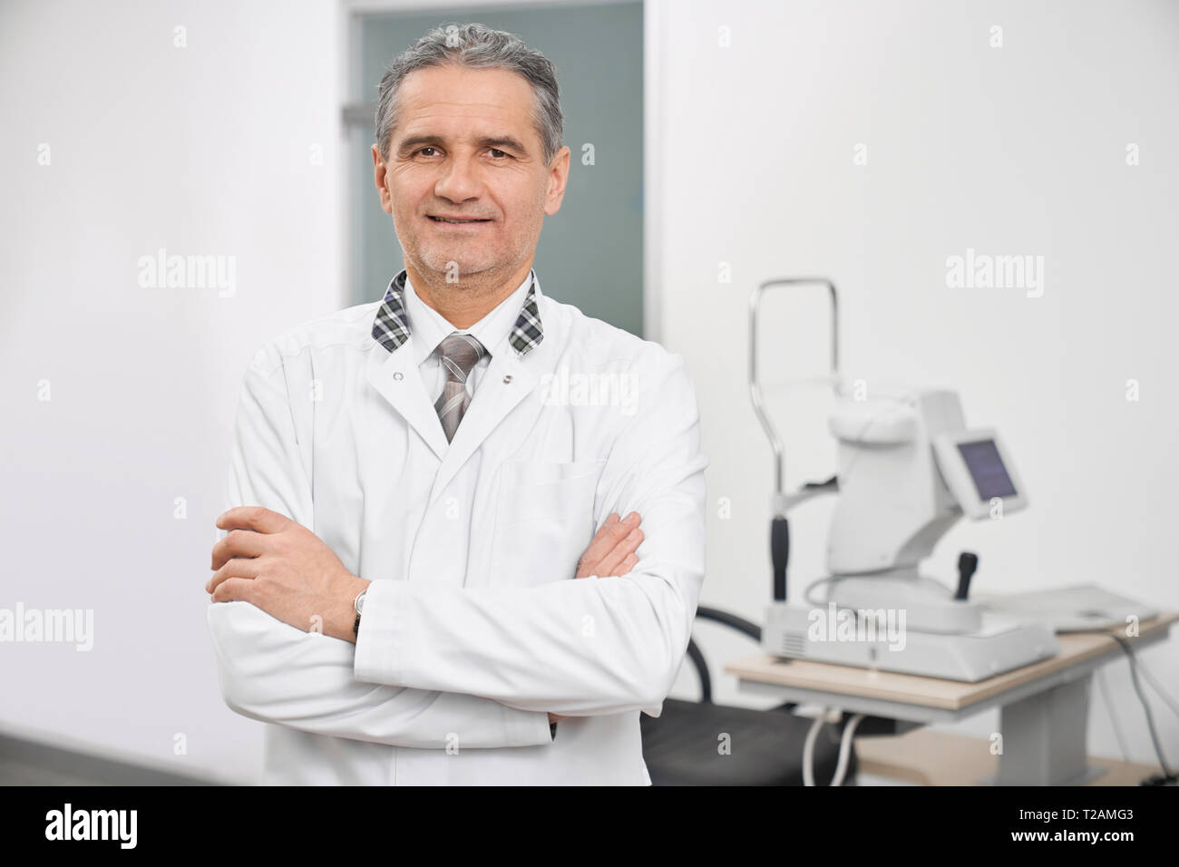 Doctor ophthalmologist wearing in white medical coat standing in
