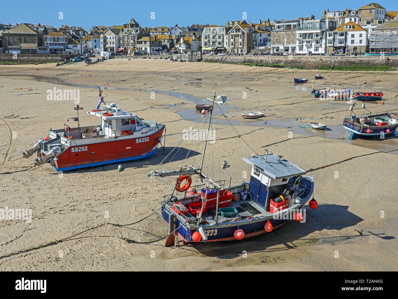 Fishing boats on the harbour beach at St Ives, a fishing port and holiday resort in north Cornwall, with tide out Stock Photo