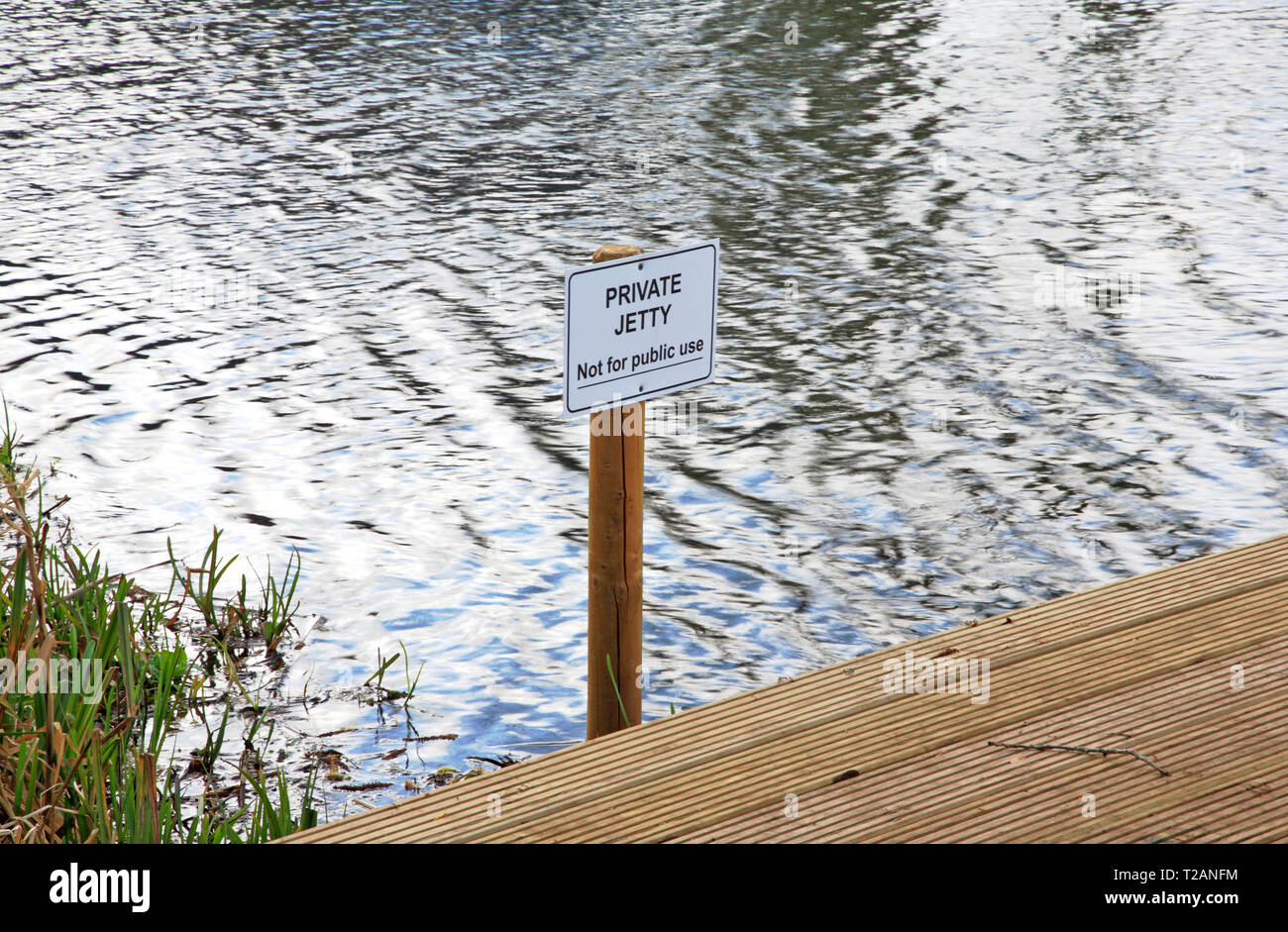 A Private Jetty sign by the River Bure upstream of Coltishall, Norfolk, England, United Kingdom, Europe. Stock Photo