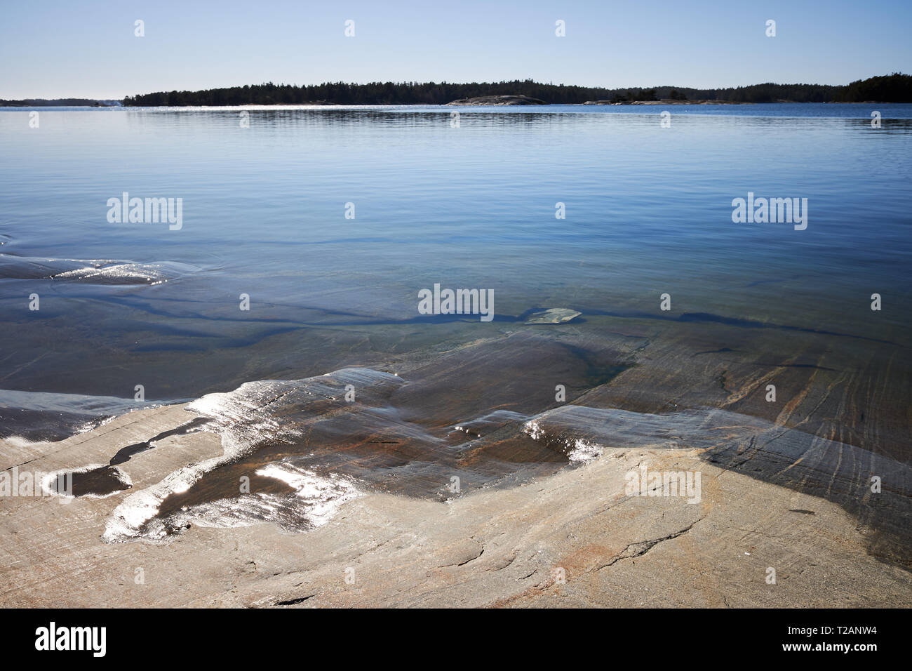 Peaceful summer landscape by the Baltic Sea in Kasnäs, Kemiö, Finland. Wide angle shot of the rocks on the seashore at Finnish archipelago. Stock Photo