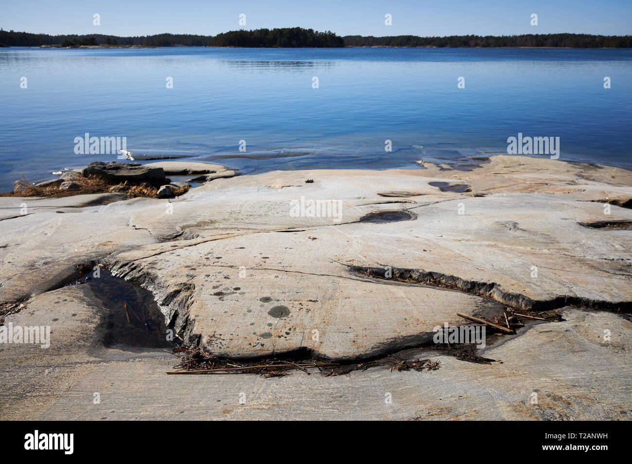 Peaceful summer landscape by the Baltic Sea in Kasnäs, Kemiö, Finland. Wide angle shot of the rocks on the seashore at Finnish archipelago. Stock Photo