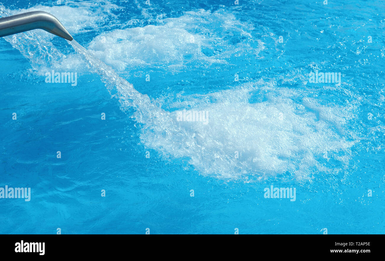 Swimming pool with streams of water background Stock Photo
