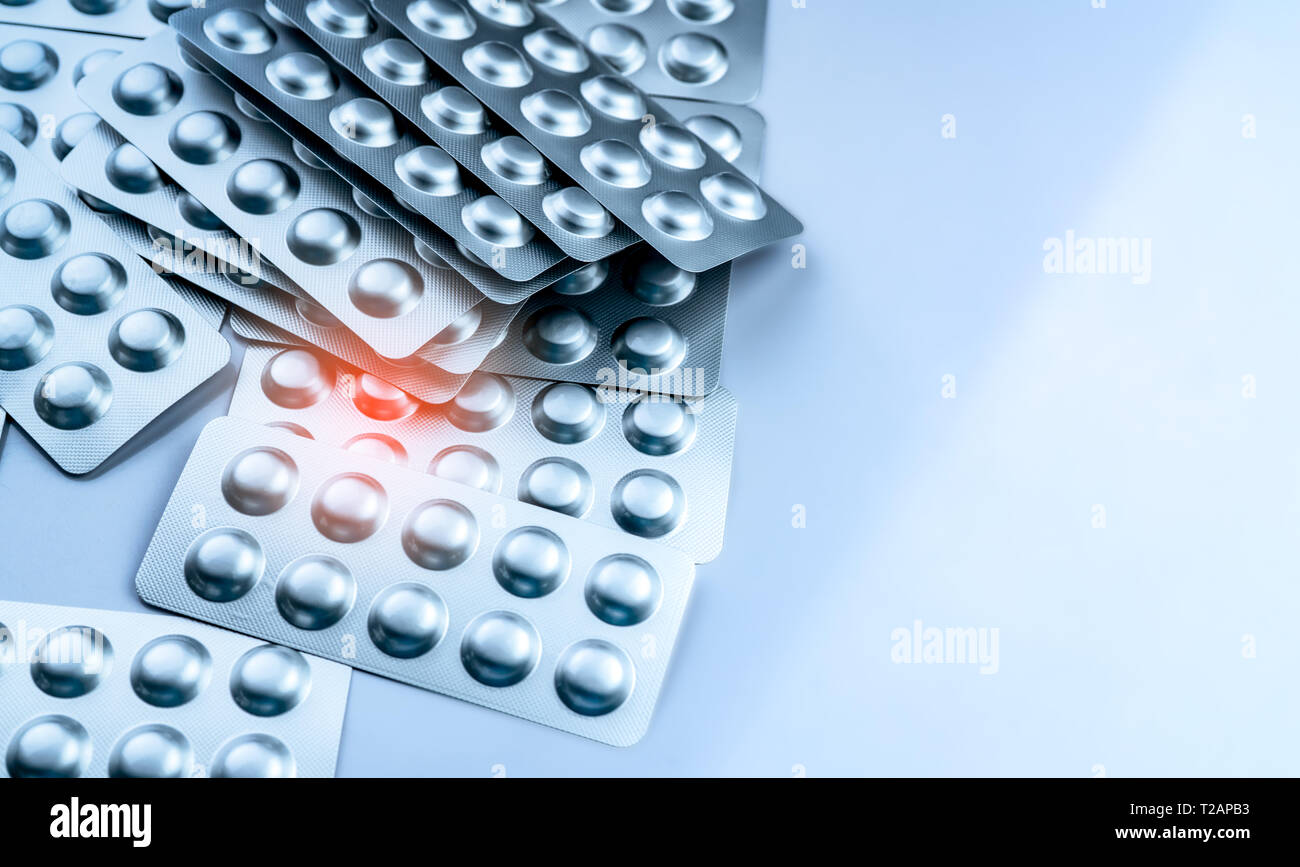 Pile of tablets pills in blister pack. Packaging in pharmaceutical industry. Pharmacy product. Drug selection to hospital. Global drug market concept. Stock Photo