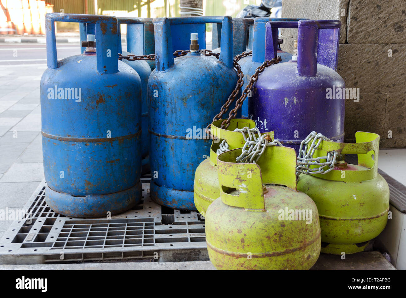 Multi-colored and different-sized gas cylinders on the street.  Bottles with liquefied petroleum gas (LPG), Propane-butane for home use. Bali Stock Photo