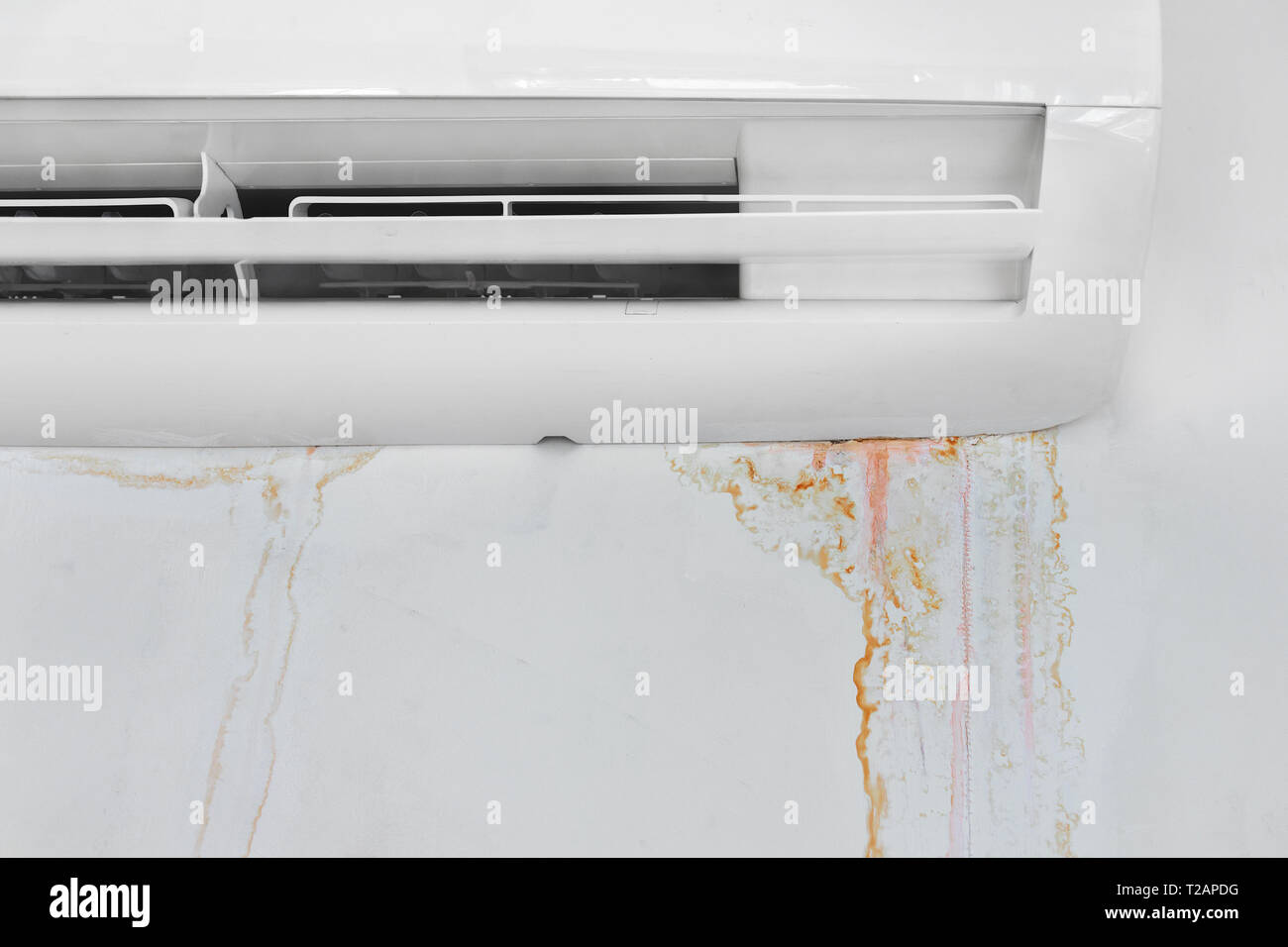 Wall with mold stain due to air conditioner leakage, close up. Mildew