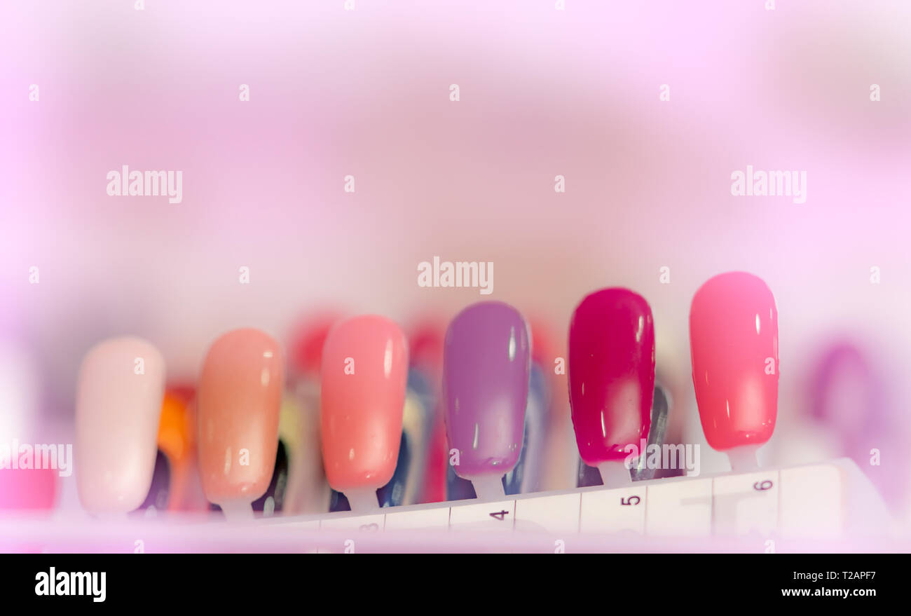 Colorful artificial Nails in nail salon shop. Set of false nails for customer to choose color for manicure or pedicure in nail salon and spa shop. Nai Stock Photo