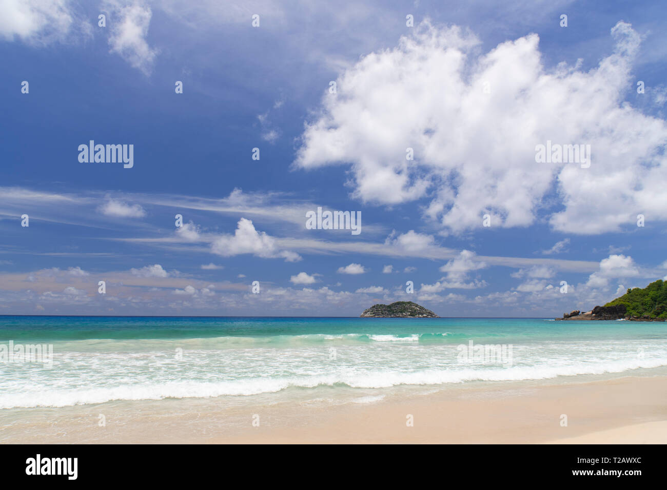 A view toward Il Aux Vaches from Grand Anse Beach on the west coast of Mahe, the Seychelles Stock Photo