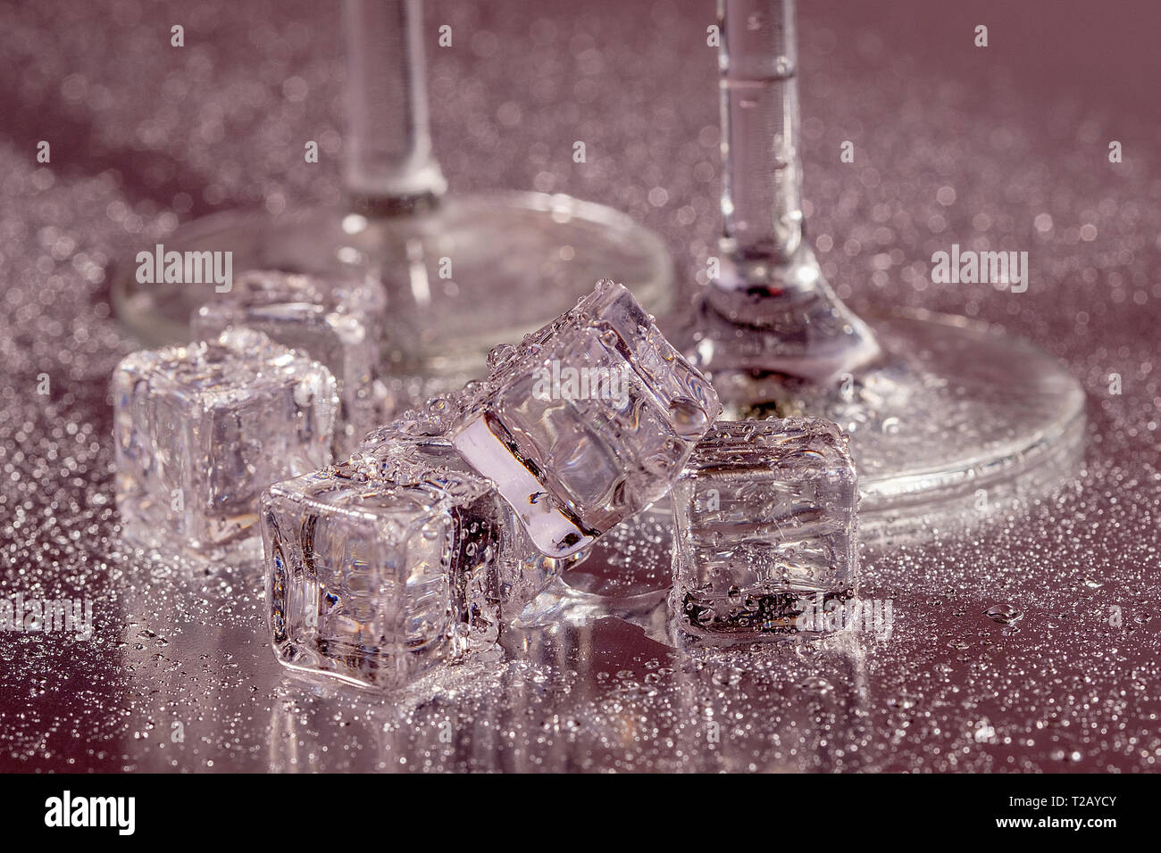 Two cocktail glasses and Ice cubes Stock Photo
