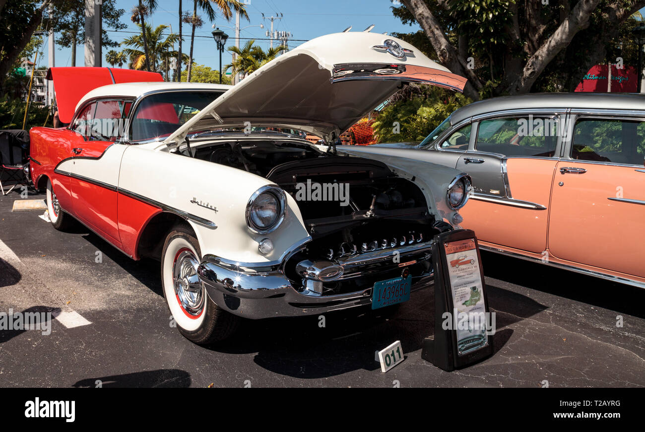 Naples, Florida, USA – March 23,2019: White and pink 1955 Oldsmobile 98 Deluxe Holiday Coupe at the 32nd Annual Naples Depot Classic Car Show in Naple Stock Photo