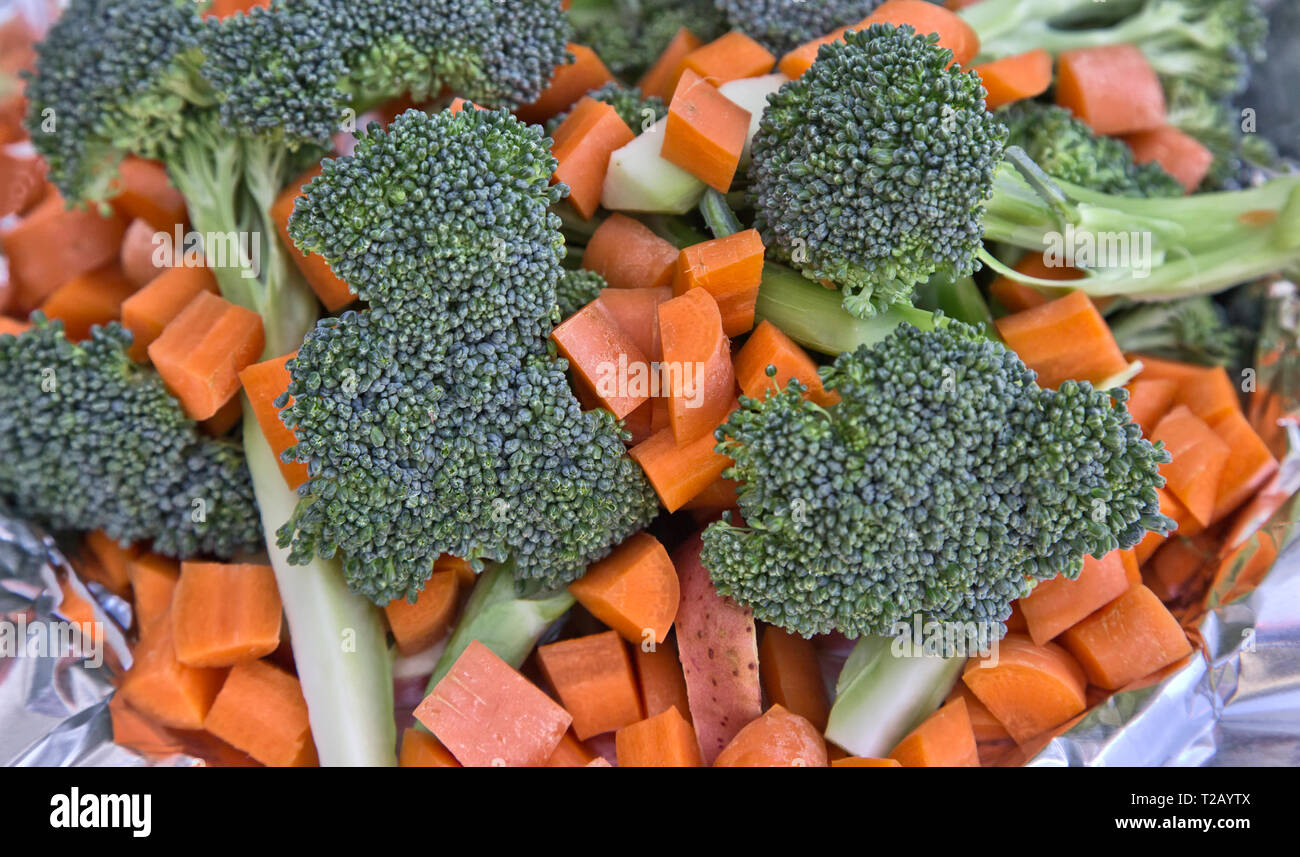 Freshly sliced & diced carrots (Daucus carota), broccoli florets (Brassica oleracea) red potato (Solanum tuberosum)  prepared for vegetable soup, Stock Photo