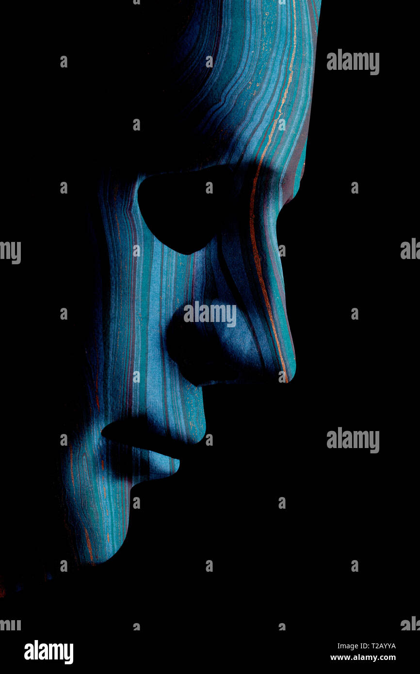 Robot face mask side view close up with textured skin and blank eyes. Black background and space for text. Artificial intelligence concept in a human  Stock Photo