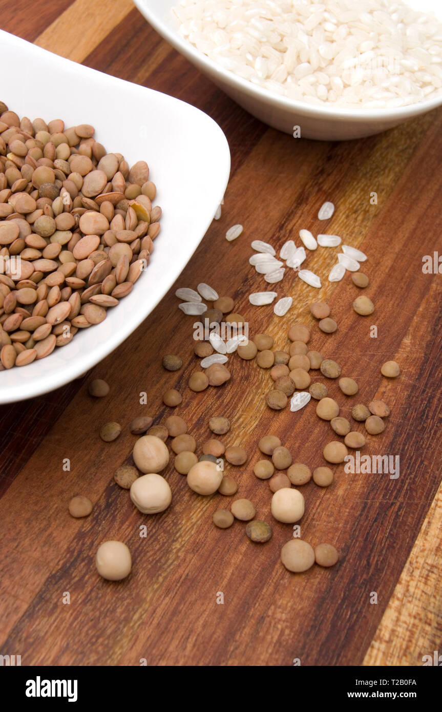 Delicious Lentils, Dried Peas and White Rice in White Bowls Stock Photo