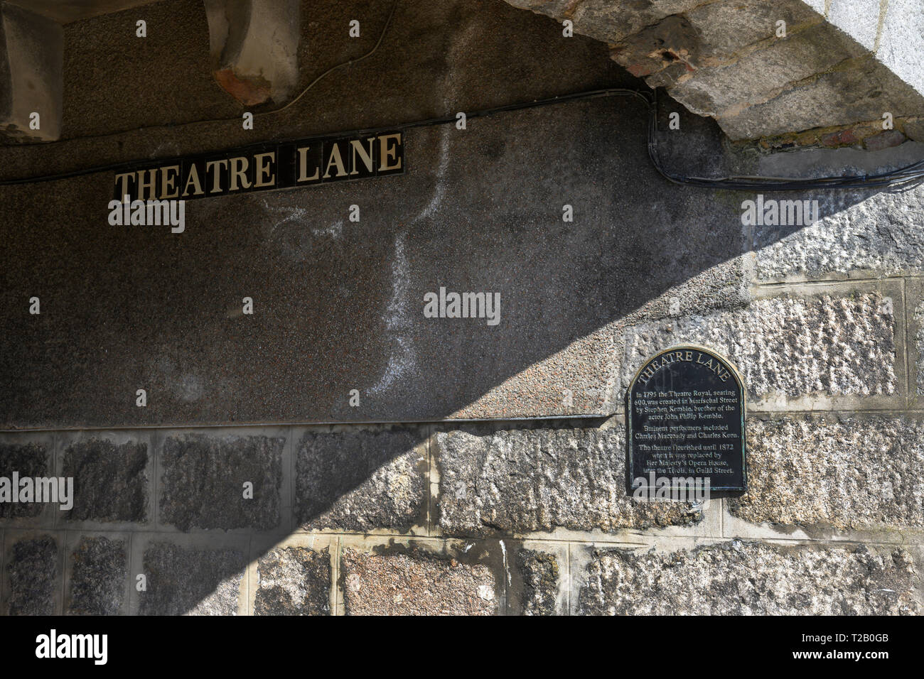 Entrance to Theatre Lane from Regent Quay, Aberdeen City Centre, Aberdeen, Aberdeenshire, Scotland, UK showing name plate and heritage plaque. Stock Photo