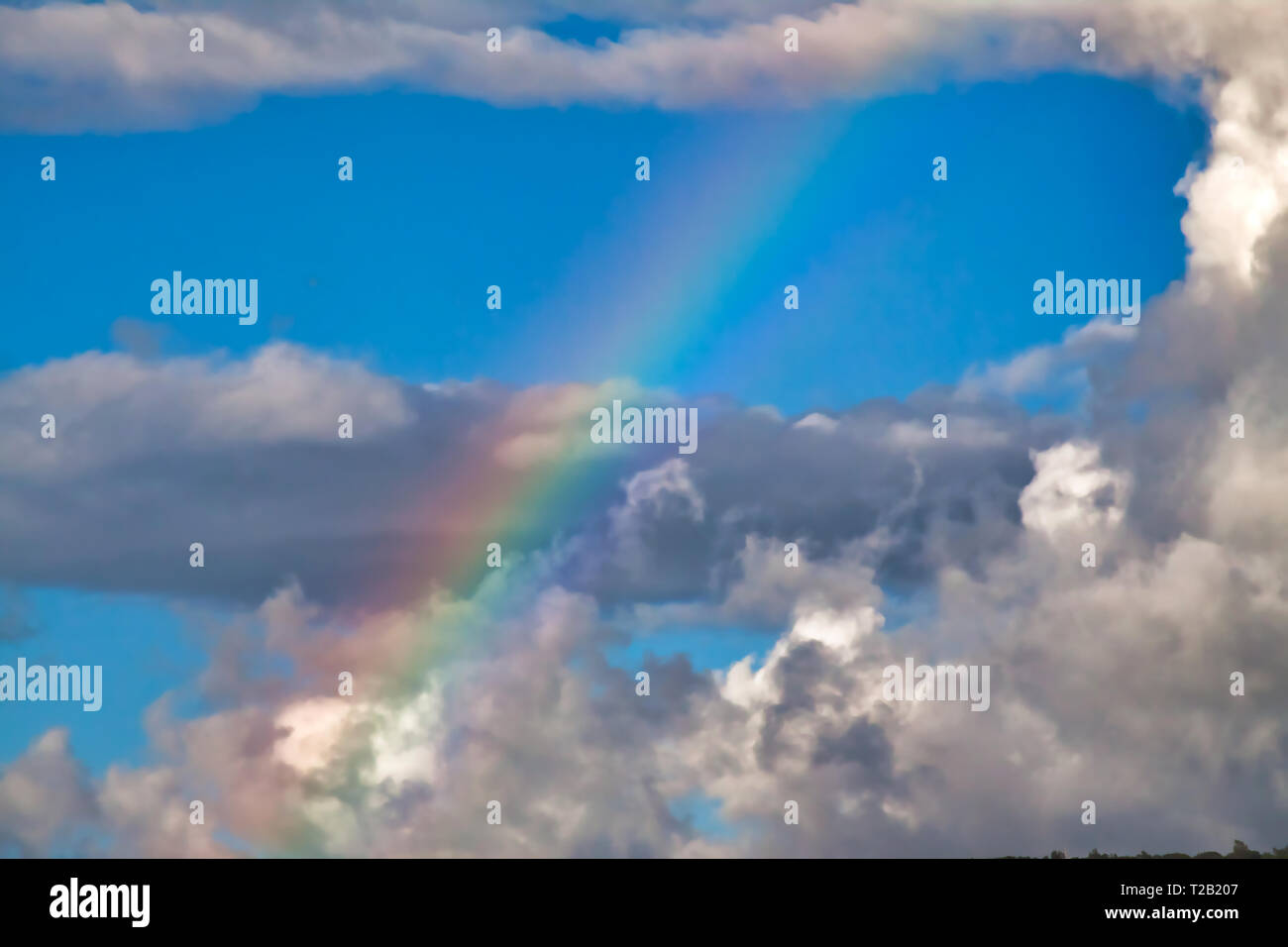Cloudy blue sky with rainbow hi-res stock photography and images - Alamy