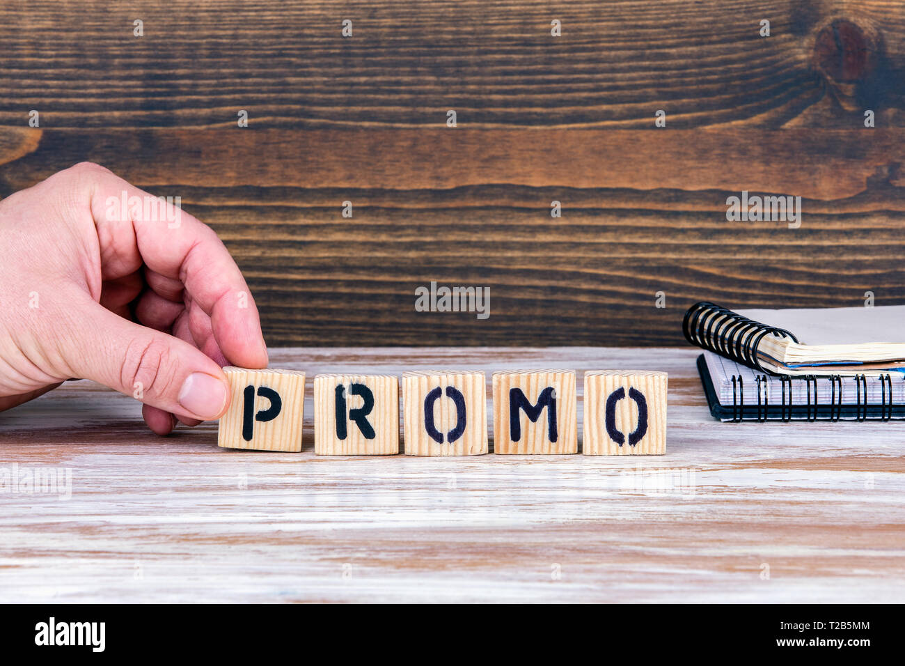 Promo. Wooden letters on the office desk, informative and communication ...