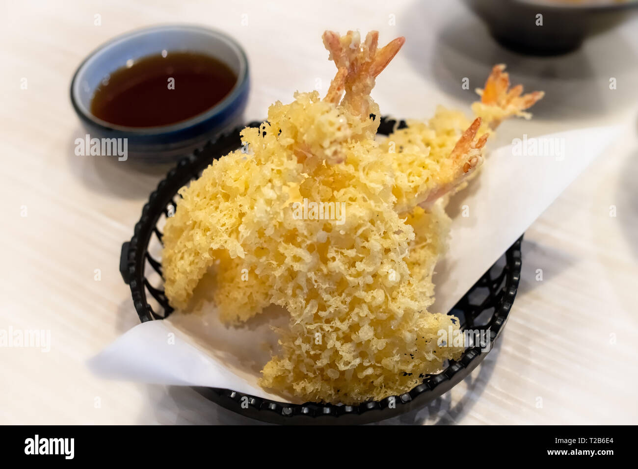 Shrimps tempura or deepfried shrimp with flour in Japanese style food with indoor low lighting. Stock Photo