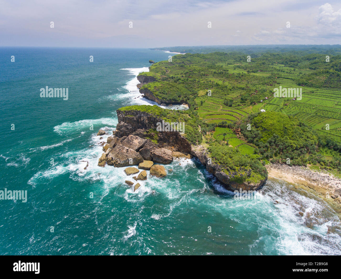 View of Java's southern coast with ancient rock crumbling down into the sea. Gunung Sewu Geopark, a UNESCO Global Geopark. Stock Photo