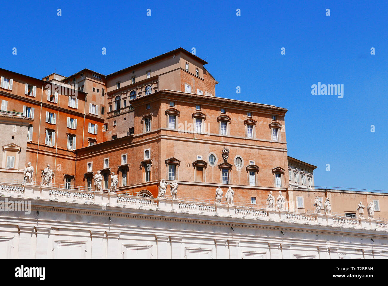 The Apostolic Palace or Papal Palace,Palace of Sixtus V( the builder) on St Peter's Square, Rome. The Papal Appartments are behind the curtains. Stock Photo