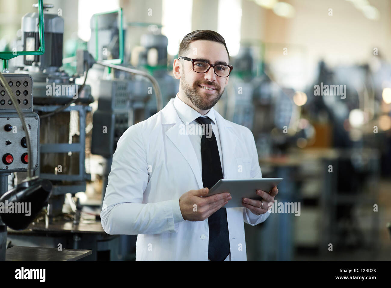 Handsome Factory Manager Holding  Tablet Stock Photo