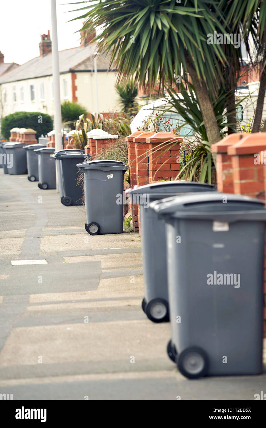 Plastic wheelie bins outside front gates awaiting emptying Stock Photo