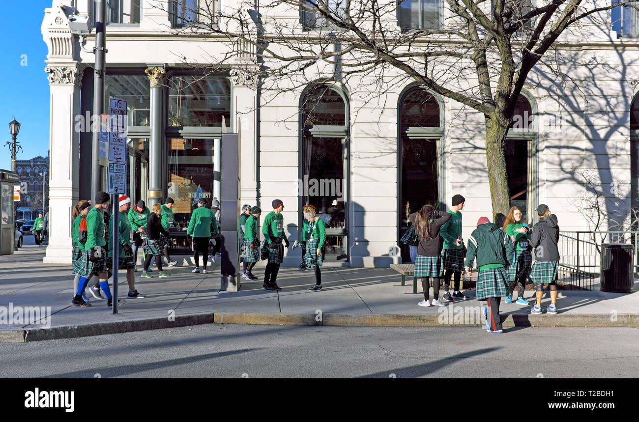 The Warehouse District fills with kilt wearing runners preparing to run in the early morning 2019 St. Patricks Day Kilt run in Cleveland, Ohio, USA. Stock Photo