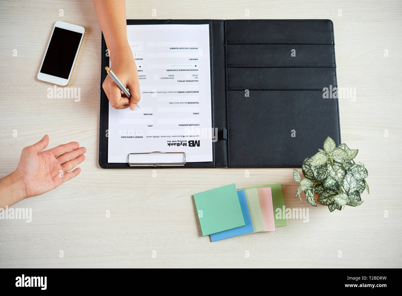 Customer filling bank form Stock Photo - Alamy