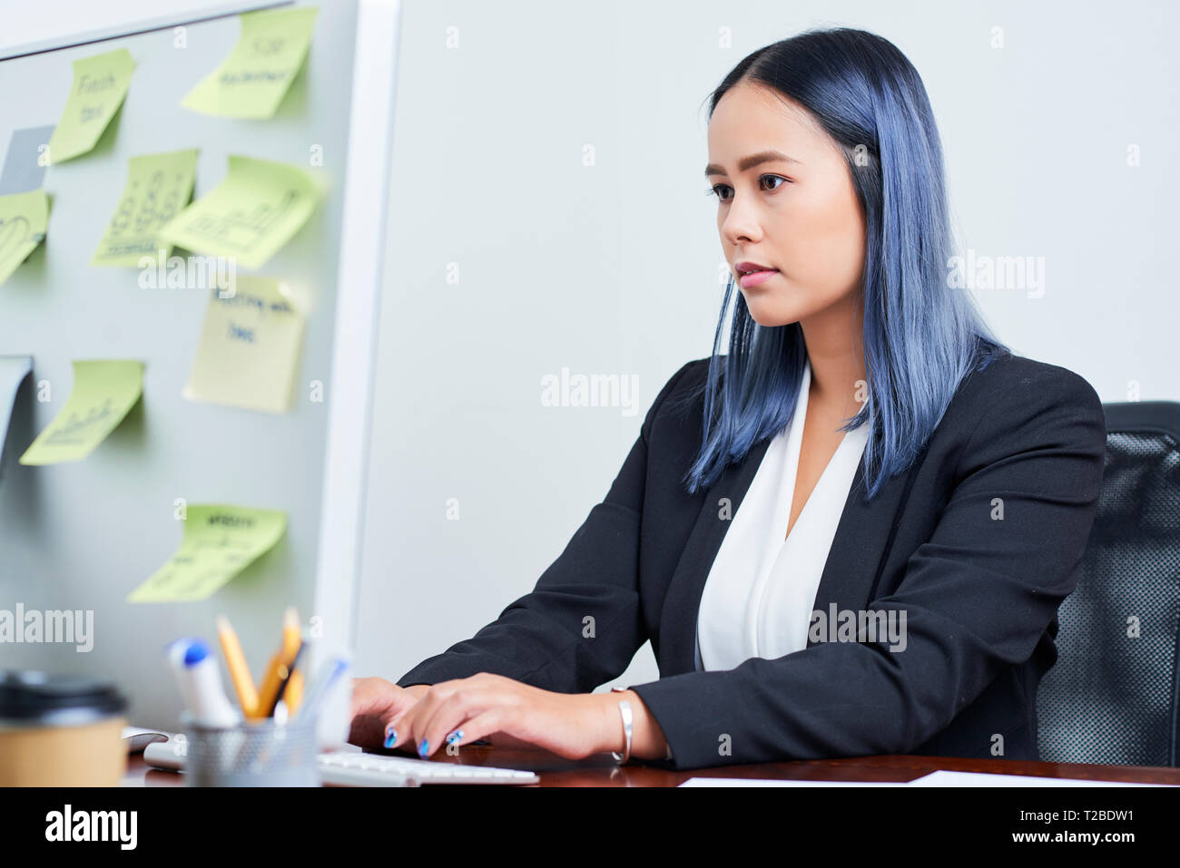 Businesswoman working on computer Stock Photo